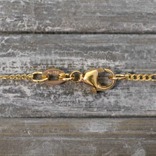 Goldkette als Figarokette diamantiert in Gelbgold 750 / 18 Karat, 65 cm lang, 1.5 mm breit, Gewicht ca. 3.7 g.